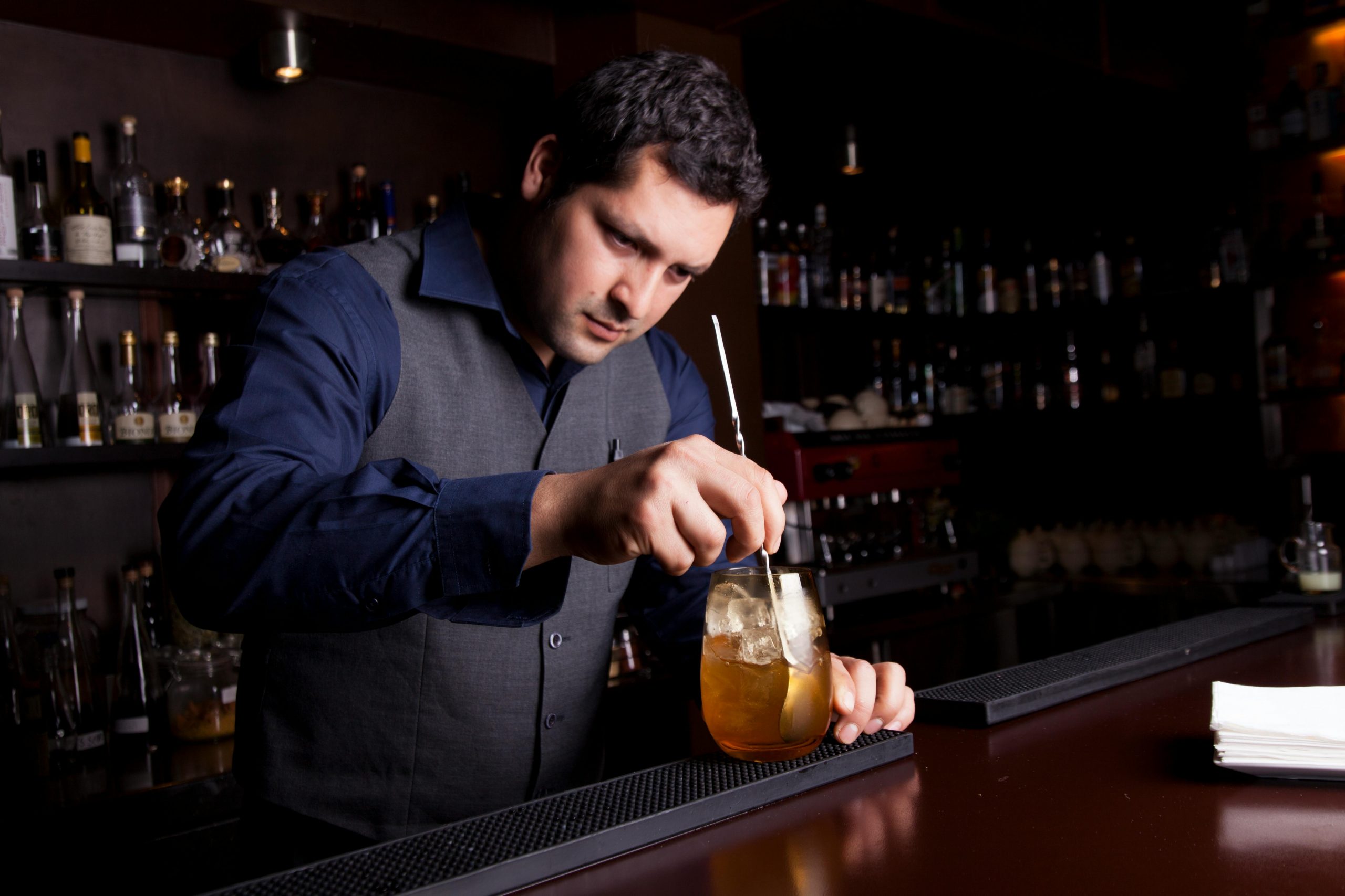 bartender stirring a cocktail